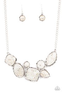 Flecks of iridescent shell-like pieces are encased in glassy white beads. Featuring hammered silver frames, the mismatched frames delicately cluster below the collar for an ethereal fashion. Features an adjustable clasp closure. 