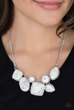 Load image into Gallery viewer, Flecks of iridescent shell-like pieces are encased in glassy white beads. Featuring hammered silver frames, the mismatched frames delicately cluster below the collar for an ethereal fashion. Features an adjustable clasp closure. 
