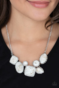 Flecks of iridescent shell-like pieces are encased in glassy white beads. Featuring hammered silver frames, the mismatched frames delicately cluster below the collar for an ethereal fashion. Features an adjustable clasp closure. 
