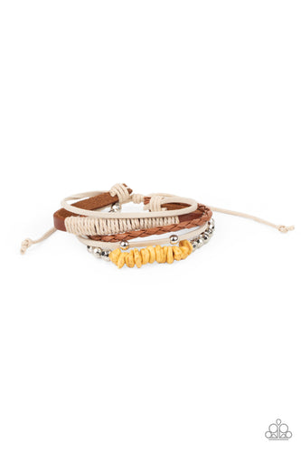 A strand of yellow pebbles and faceted silver beads joins rustic suede and leather bands around the wrist, creating earthy layers. Features an adjustable sliding knot closure.