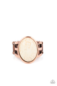 An oval white stone is nestled inside an antiqued copper frame that attaches to layered copper bands, creating a rustic stone centerpiece atop the finger. Features a stretchy band for a flexible fit. 