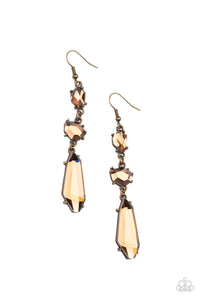 Featuring raw cuts, an asymmetrical collection of faceted smoky topaz gems trickles from the ear, creating a smoldering chandelier. Earring attaches to a standard fishhook fitting.