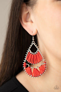 Three abstract silver fittings section off the inside of a pronged teardrop. Red thread is wrapped around the bar-like fittings, creating colorful loom-like accents. Earring attaches to a standard fishhook fitting.