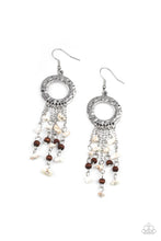 Load image into Gallery viewer, Tapered tassels of dainty wooden beads and white pebbles stream from the bottom of a hammered silver hoop, creating an earthy fringe. Earring attaches to a standard fishhook fitting.
