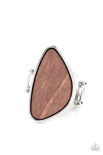 An asymmetrical piece of rustic wood is nestled inside a sleek silver frame that thickens into a shimmery band around the finger, creating a refined centerpiece. Features a stretchy band for a flexible fit.