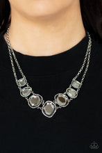 Load image into Gallery viewer, Encased in hammered asymmetrical silver frames, an imperfect collection of faceted smoky gems are suspended from two shimmery silver chains as they double-link below the collar for a dramatic effect. Features an adjustable clasp closure.
