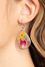 Load image into Gallery viewer, A colorful collection of wildflowers is encased inside a glassy teardrop casing bordered in silver, creating a whimsical display. Earring attaches to a standard fishhook fitting.
