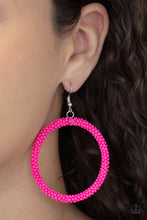 Load image into Gallery viewer, A dainty strand of vivacious pink seed beads wrap around a silver hoop, creating a bubbly hoop. Earring attaches to a standard fishhook fitting.
