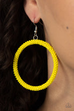 Load image into Gallery viewer, A dainty strand of Illuminating seed beads wrap around a silver hoop, creating a bubbly hoop. Earring attaches to a standard fishhook fitting. 
