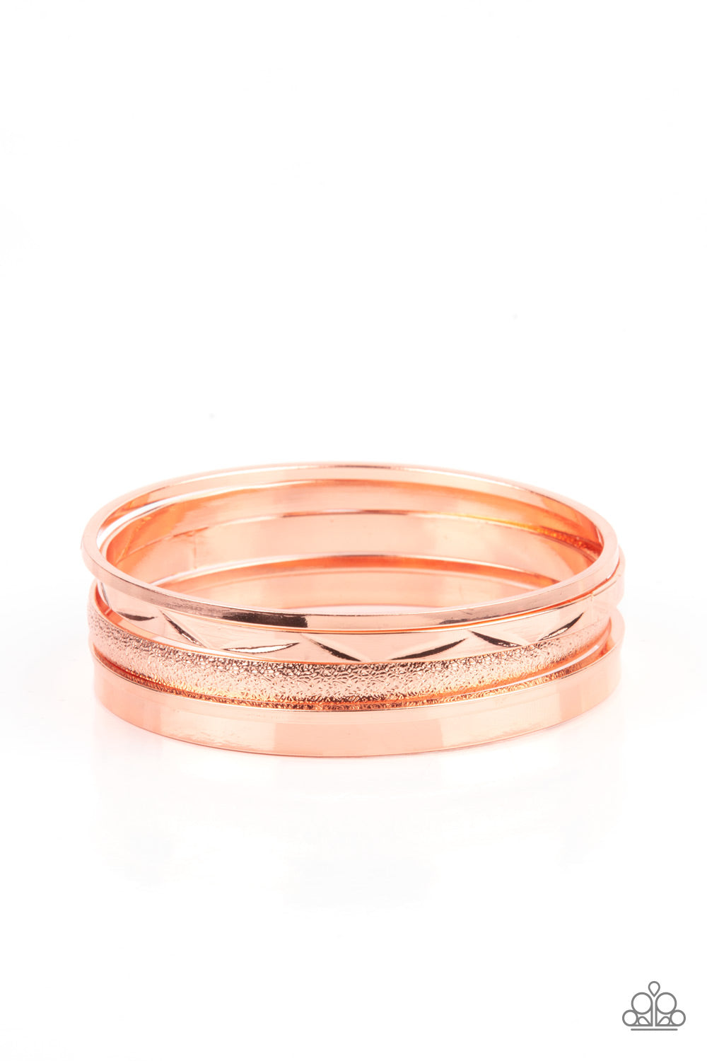 Varying in hammered, textured, and high sheen finishes, a mismatched collection of shiny copper bangles stacks across the wrist for a classic fashion. 