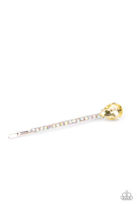 A golden yellow teardrop gem adorns the corner of a bobby pin that is adorned in opalescent rhinestones for a glamorous finish. 