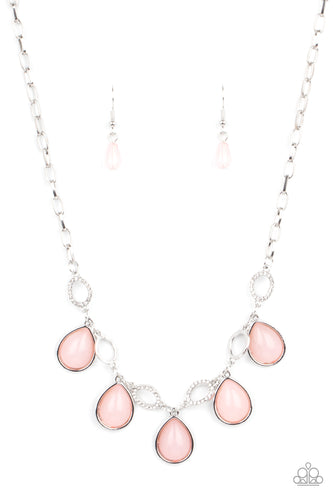 Encased in sleek silver frames, opaque pink teardrop beads link with dainty white rhinestone encrusted silver ovals below the collar, creating a mystical fringe. Features an adjustable clasp closure. 