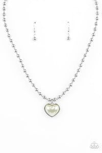 Featuring a pearly Green Ash center, a charming heart pendant glides along a strand of silver beads below the collar for a romantic flair. Features an adjustable clasp closure. 