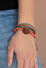 Load image into Gallery viewer, Featuring a wooden floral centerpiece, mismatched strands of orange wooden beads, blue leather, brown suede, and topaz crystal-like beads layer across the wrist for a seasonal flair. Features an adjustable sliding knot closure.
