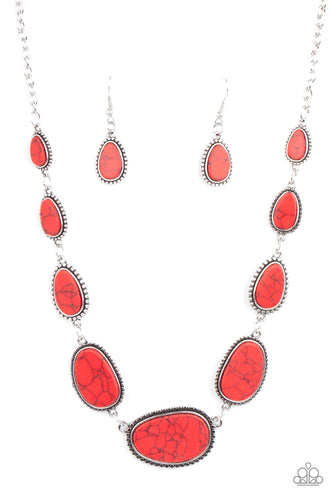 Encased in frames of flattened silver studs, pieces of flat red stone teardrops and asymmetrical ovals gradually increase in size as they link below the collar for an artisan inspired look. Features an adjustable clasp closure.