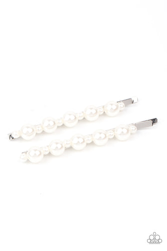 Dainty and classic pearls alternate along a pair of silver bobby pins, creating a bubbly display.