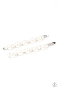 Dainty and classic pearls alternate along a pair of silver bobby pins, creating a bubbly display.