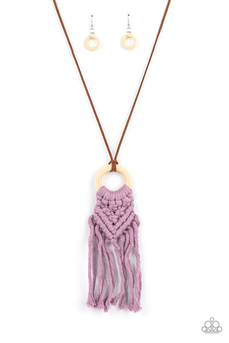 Strands of Amethyst Orchid yarn-like thread delicately weaves into a knotted macrame pattern at the bottom of a white wooden hoop. Dainty strands of brown suede knot around the pendant for an earthy flair. Features an adjustable clasp closure.