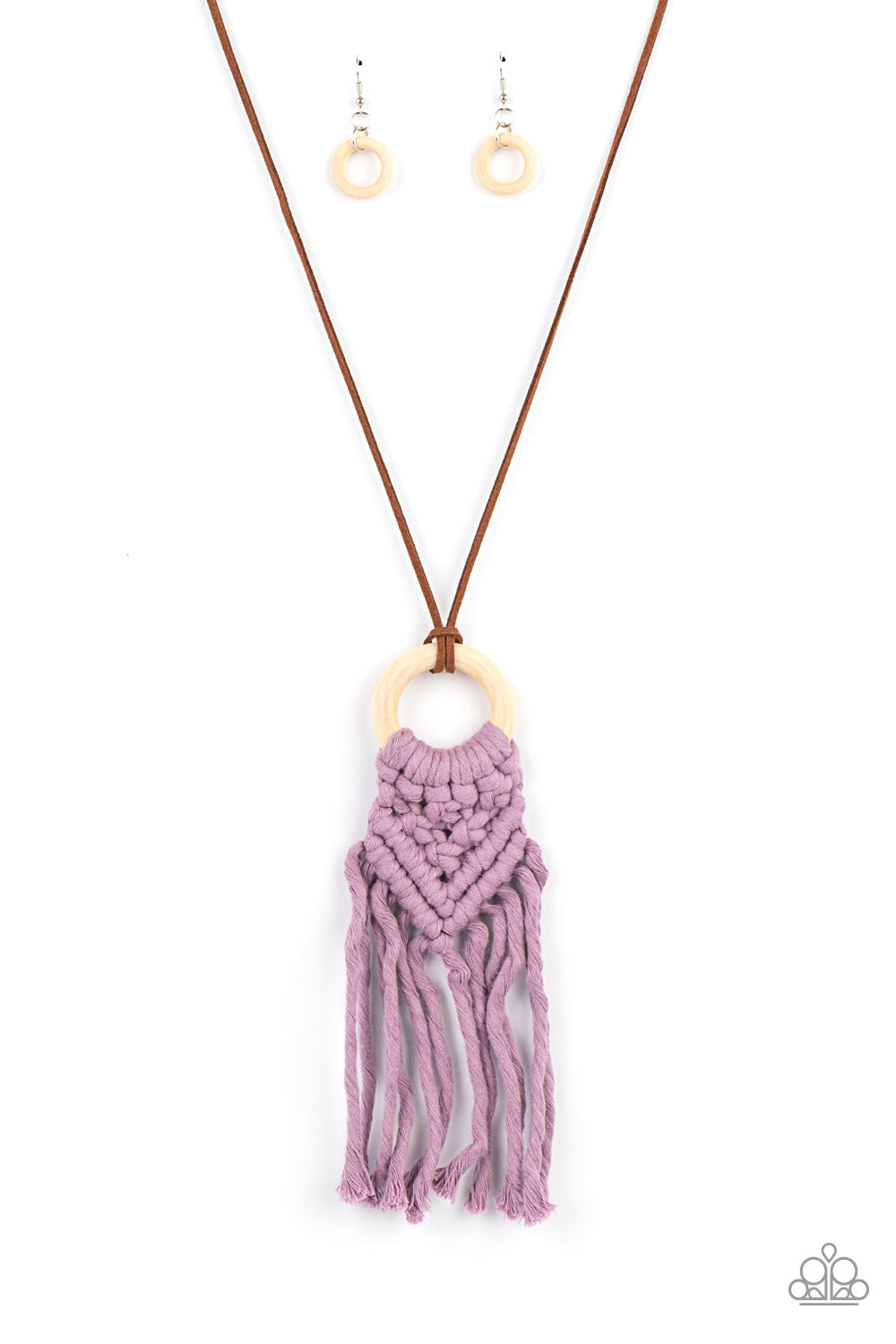 Strands of Amethyst Orchid yarn-like thread delicately weaves into a knotted macrame pattern at the bottom of a white wooden hoop. Dainty strands of brown suede knot around the pendant for an earthy flair. Features an adjustable clasp closure.