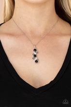 Load image into Gallery viewer, Featuring classic round and regal emerald style cuts, a glittery collection of black, hematite, and white rhinestones delicately coalesce into a glamorous pendant below the collar. Features an adjustable clasp closure.
