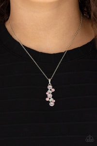 Featuring classic round and regal emerald style cuts, a glittery collection of pink and white rhinestones delicately coalesce into a glamorous pendant below the collar. Features an adjustable clasp closure.