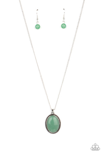 An oval jade stone is pressed into the center of a studded silver frame, creating a tranquil pendant below the collar. Features an adjustable clasp closure.