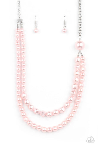 A dramatically oversized pink pearl gives way to two mismatched strands of classic pink pearls that graduate in size and imperfect finishes, adding a timeless twist to the classic pearl palette. Features an adjustable clasp closure. 