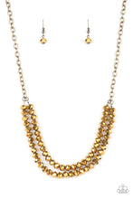 Load image into Gallery viewer, A rugged brass chain connects a double strand of aurum beads. The mirrored multi-faceted beads connect below the collar for a fiercely stunning style. Features an adjustable clasp closure.
