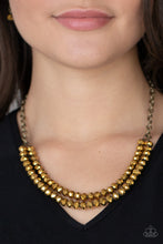 Load image into Gallery viewer, A rugged brass chain connects a double strand of aurum beads. The mirrored multi-faceted beads connect below the collar for a fiercely stunning style. Features an adjustable clasp closure.
