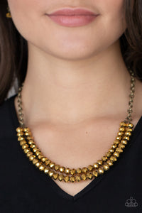 A rugged brass chain connects a double strand of aurum beads. The mirrored multi-faceted beads connect below the collar for a fiercely stunning style. Features an adjustable clasp closure.