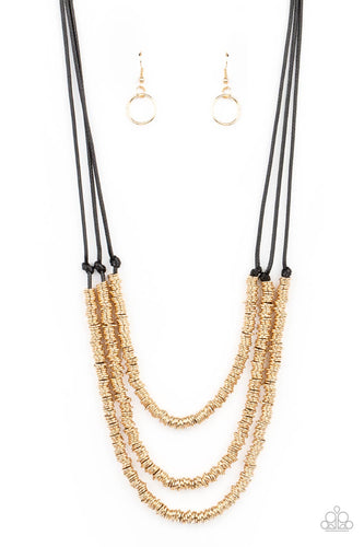 A seemingly infinite collection of dainty gold rings are knotted in place along three black cords, creating edgy layers across the chest. Features an adjustable clasp closure.