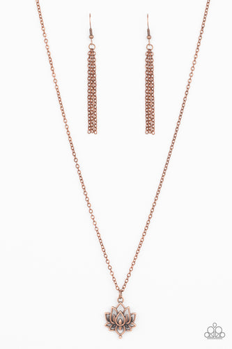 A rustic copper lotus blooms along a dainty copper chain, creating a whimsical pendant below the collar. Features an adjustable clasp closure