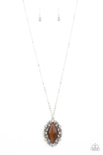 Load image into Gallery viewer, Dotted in glassy white rhinestones, leafy silver filigree blooms from an oversized brown cat&#39;s eye stone, creating an enchanted pendant at the bottom of a lengthened silver chain. Features an adjustable clasp closure.
