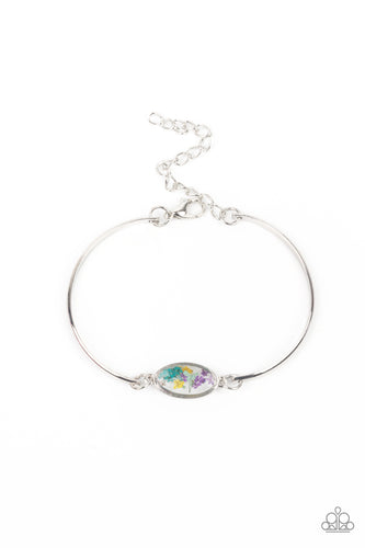 A collection of colorful wildflowers is encased in a glassy casing bordered in silver that attaches to two shiny silver bars around the wrist, creating a whimsically dainty centerpiece. Features an adjustable clasp closure.  Sold as one individual bracelet.