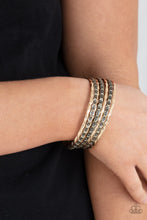 Load image into Gallery viewer, Embossed in slanted ribbons of textured and studded hammered patterns, trios of mismatched brass and gold bangles stack across the wrist for an intense industrial vibe.
