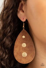 Load image into Gallery viewer, The front of a distressed leather teardrop frame is adorned into three glistening gold paint drops, creating a rustic elegance. Earring attaches to a standard fishhook fitting.
