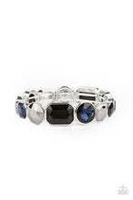 Load image into Gallery viewer, Encased in sleek silver frames, a smoldering collection of round and emerald cut black, blue, and hematite rhinestones glide along stretchy bands around the wrist, creating a sparkly industrial statement piece.
