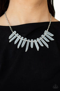 Separated by dainty silver beads, an opaque collection of glassy-like icicle beads fan out below the collar, creating an icy fringe. Features an adjustable clasp closure.
