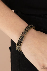 Filled with leafy tropical floral filigree, two antiqued brass frames connect into a whimsical bangle-like cuff around the wrist. Features a hinged closure.