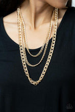 Load image into Gallery viewer, Bold layers of glistening gold chain of varying sizes and textures, fall like a weighty medal across the chest creating a shimmering industrial effect. Features an adjustable clasp closure. 
