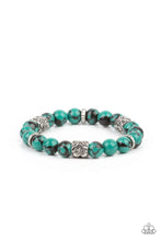 Load image into Gallery viewer, An earthy collection of glassy green and black beads, textured silver rings, and floral embossed beads are threaded along stretchy bands around the wrist, creating a seasonal centerpiece
