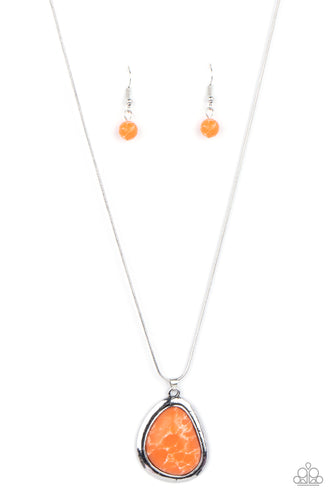A marbled orange stone is encased in a simple asymmetrical silver teardrop frame. The earthy pendant falls below the collar creating a natural and enduring impact. Features an adjustable clasp closure.
