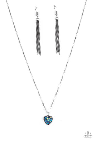 A lovely gunmetal heart frame, encrusted with a glittery faux druzy blue stone creates a fun 3D pendant that falls below the collar from a dainty gunmetal chain. Features an adjustable clasp closure