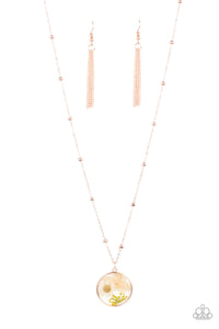 A delightful bouquet of pressed flowers encased in a rose gold frame gently sway from a delicate rose gold chain accented with rose gold beads. Features an adjustable clasp closure. 