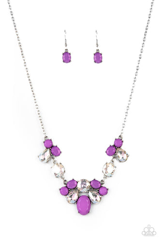 Varying in opacity and shape, mismatched purple beads attach to oversized white rhinestones, creating bubbly frames that delicately link into an ethereal display below the collar. Features an adjustable clasp closure 