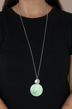 Load image into Gallery viewer, Featuring a glistening iridescence, an Green Ash shell-like disc attaches to a shiny silver frame at the bottom of a lengthened silver chain, creating a summery pendant. Features an adjustable clasp closure.
