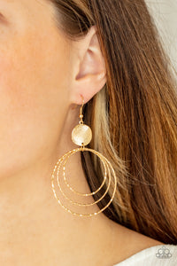 A shimmery wavy gold disc links atop a collection of three delicately hammered gold rings in concentric sizes for an out-of-this-world finish. Earring attaches to a standard fishhook fitting.