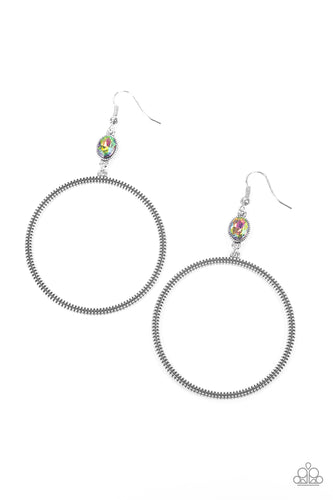 A slim oversized silver ring, highlighted by two concentric circles of dotted texture, dangles from an oval oil spill gem for an edgy refined look. Earring attaches to a standard fishhook fitting.  Sold as one pair of earrings.