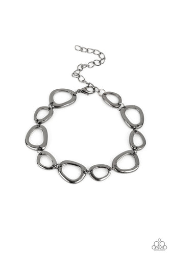 An array of irregular shaped gunmetal rings link together and make their way around the wrist for a simple yet stylish avant-garde fashion. Features an adjustable clasp closure. 