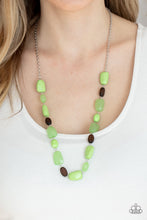 Load image into Gallery viewer, Varying in opacity, a mixed assortment of faceted Apple Green beads delicately link with dainty wooden beads across the chest, creating a whimsically earthy display. Features an adjustable clasp closure. 
